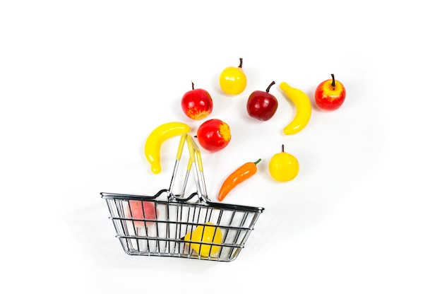 In the shopping basket  the supermarket flying fruit apples, pears, bananas, on a white background isolated.