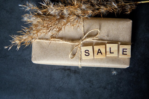 Shopping basket with gift box in waxed paper. The Concept Of Online Shopping. Christmas sales or gift shopping. Sale for New Year and Christmas. Buying gifts.