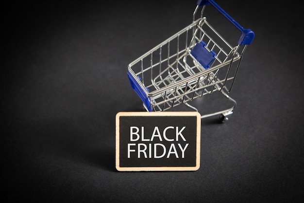 Shopping cart on the black background Black Friday