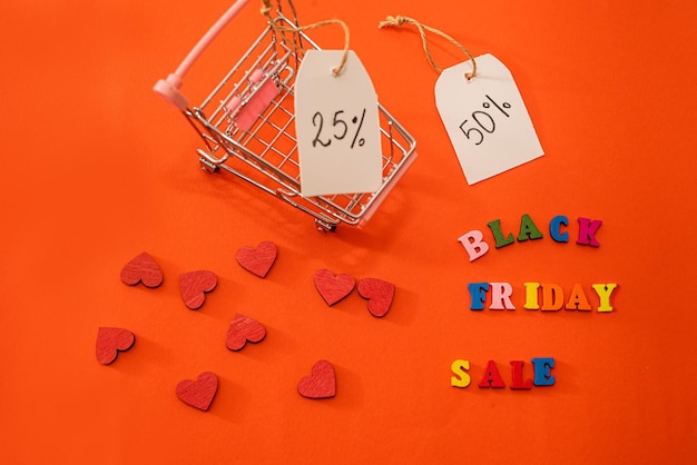 Shopping cart and black friday text with wooden letters outlined and discounts isolated