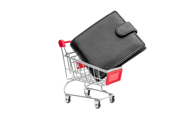 Shopping cart and black wallet with money on white Business concept