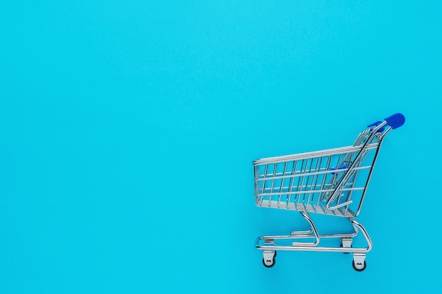 Shopping cart on blue background