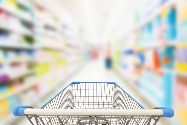 Shopping cart in blur supermarket background