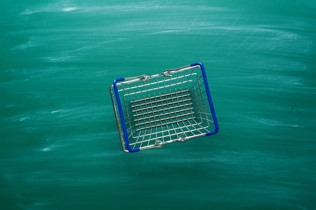 Shopping cart on chalkboard background