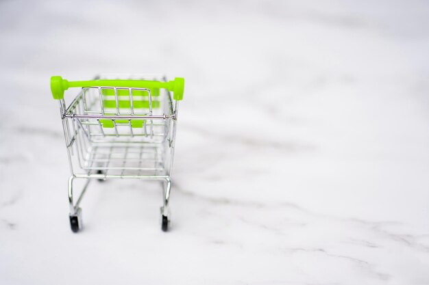 Shopping cart. Copy space for text or design. Stainless steel shopping trolley upside down. Minimalist shopping concept.