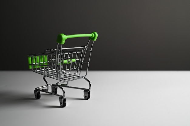 Shopping cart on a dark background with shadows