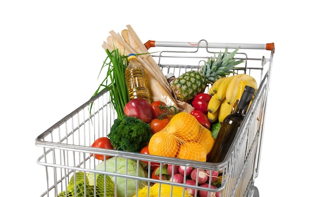 Shopping cart filled with various groceries in store