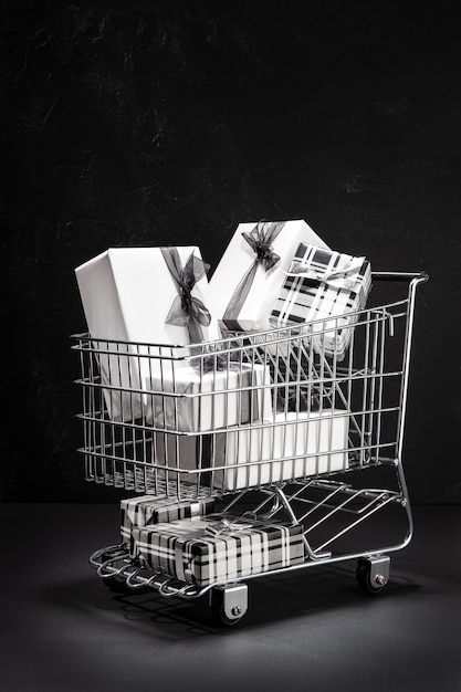 Shopping cart full of gift boxes. Sopping on Black friday concept.