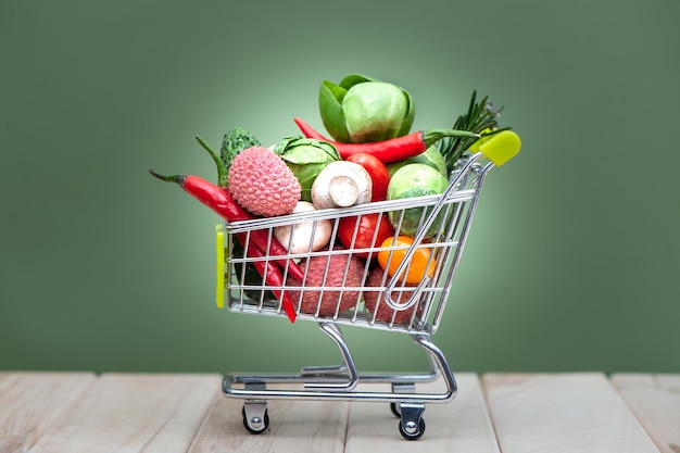 shopping cart full space for text banner health bio organic food concept cart in supermarket full of fruits and vegetables