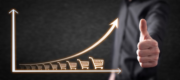 Photo shopping cart and growth graph. increase in sales