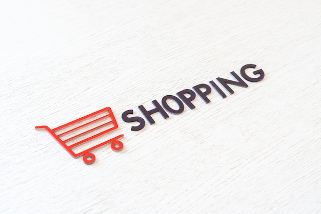 A shopping cart icon concept cut out letters, sale store business, simple minimalistic