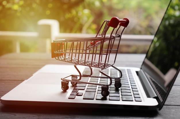 Photo shopping cart and laptop on table