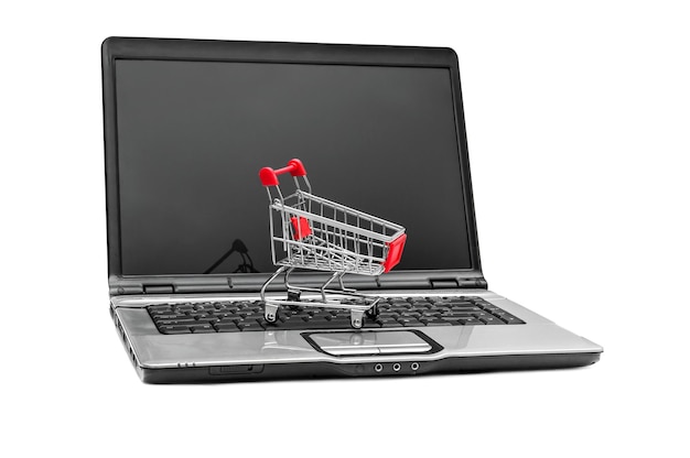 Shopping cart on opened laptop Isolated on white