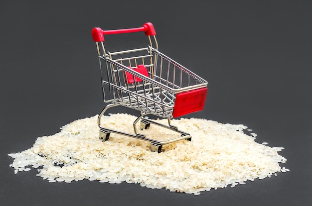 Shopping cart on pile of raw riceShopping cart on pile of raw rice