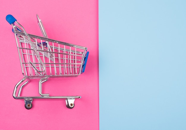 Shopping cart on the pink and blue