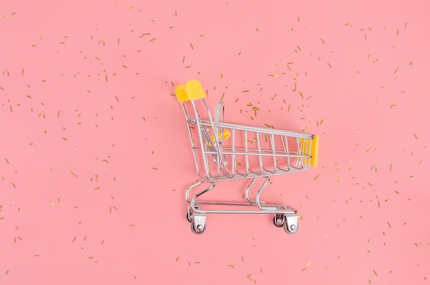 Shopping cart on pink festive background