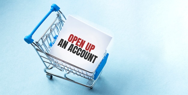 Shopping cart and text OPEN UP AN ACCOUNT on white paper note list