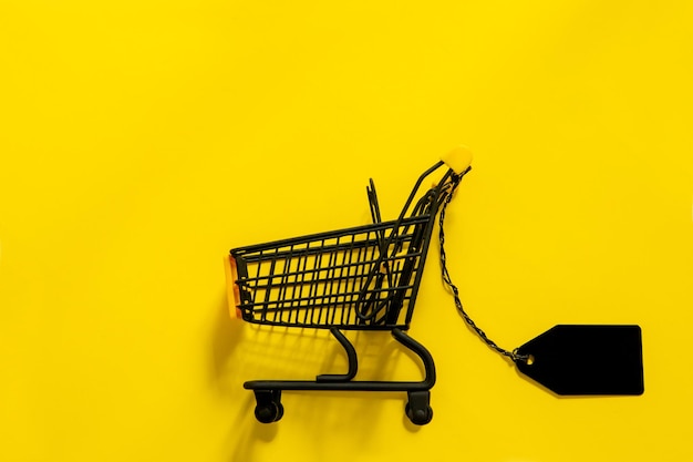 Shopping cart with black label on yellow background