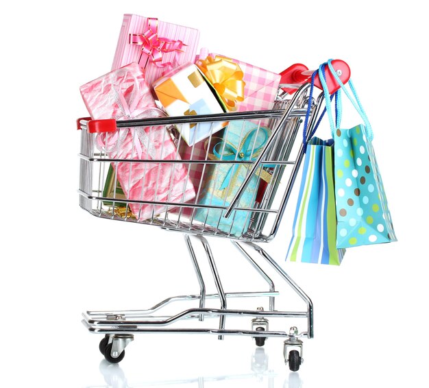Shopping cart with bright gifts and paper bags isolated on white