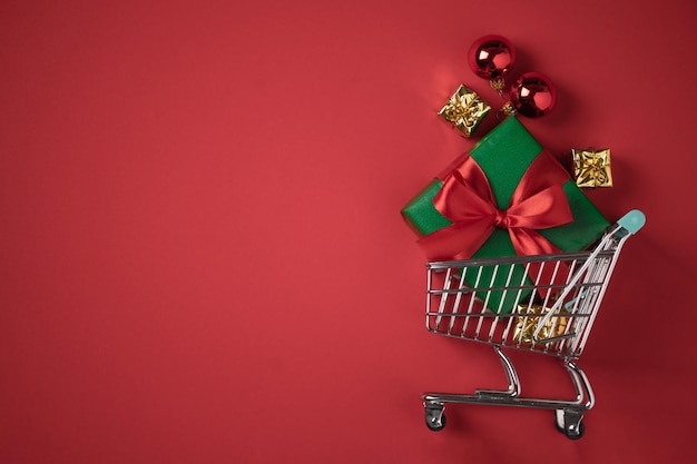 Shopping cart with Christmas presents top view. Christmas and New year shopping concept