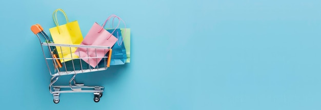Photo a shopping cart with colorful paper bags on a light blue background