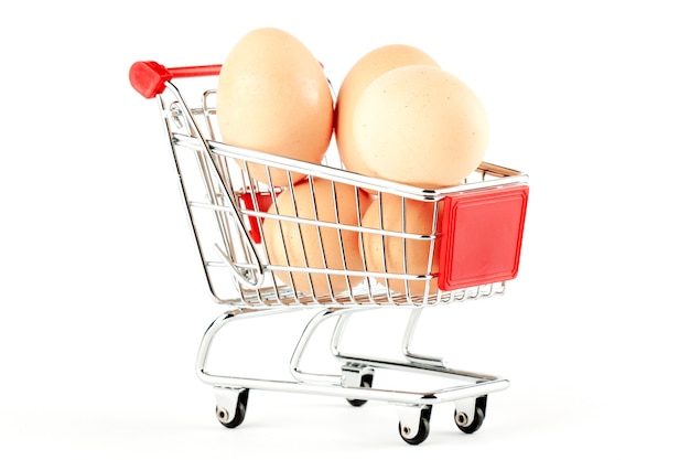 Shopping cart with eggs on the white background