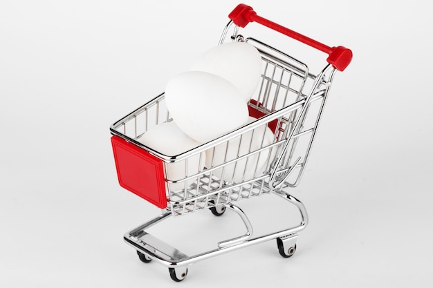 Shopping Cart with Eggs on the white background