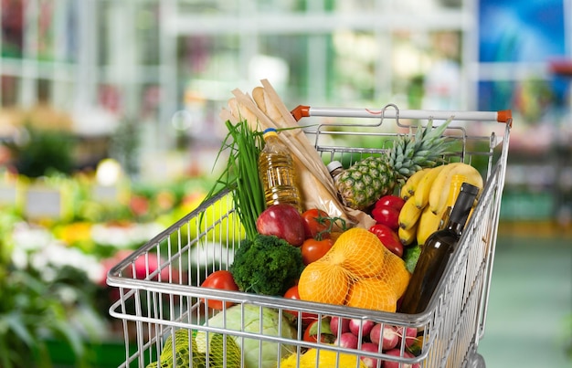 Shopping cart with fruits and vegetables at the market.