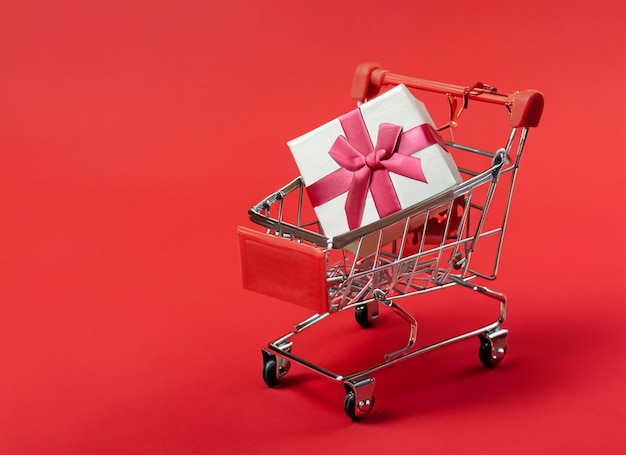 Shopping cart with gift box background