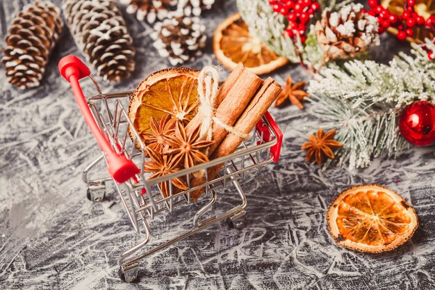 Shopping cart with gift or present on concrete table. 