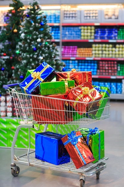 Shopping cart with gifts in supermarket 