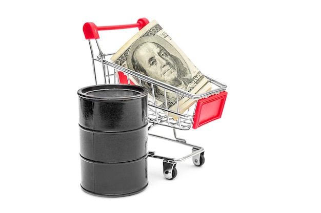 Shopping cart with money and barrel of crude oil on white