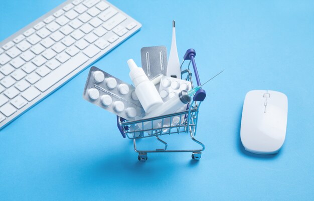 Shopping cart with pills, medical bottle, thermometer