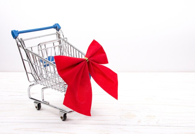 Shopping cart with a red bow