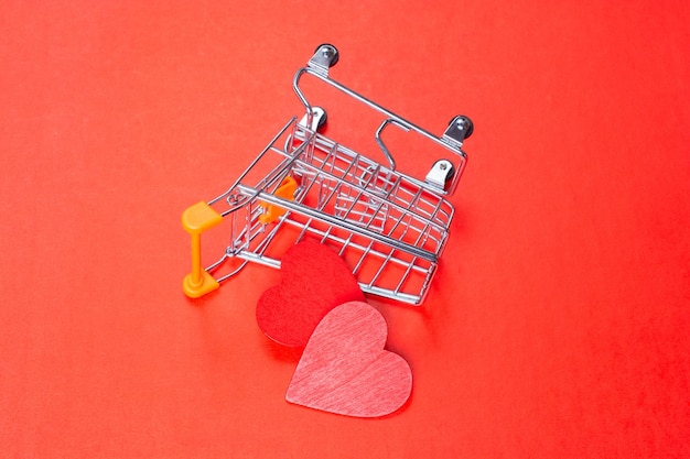 Shopping cart with a red heart The concept of shopping