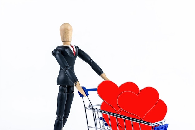 Shopping cart with red hearts paper on white background