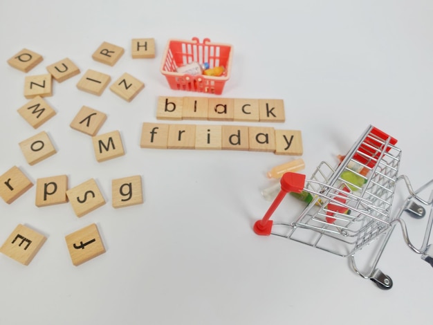 A shopping cart with scrabble tiles and a shopping cart with the letters black friday on it.