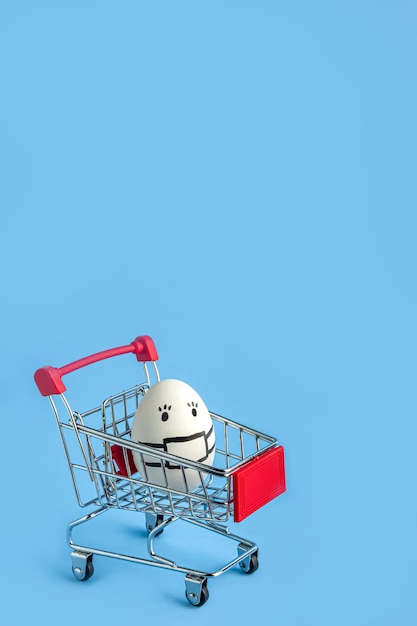 Shopping cart with a white mask with painted mask on blue background