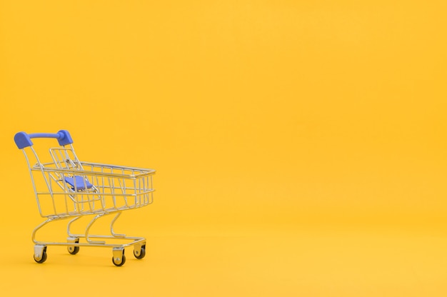 Shopping cart with yellow background