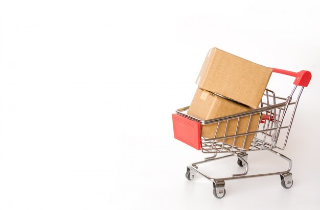 Shopping concept : Cartons or Paper boxes in red shopping cart on white background. online