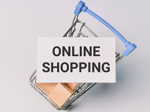 Photo shopping concept phrase online shopping on white card with trolley full of wooden cubes