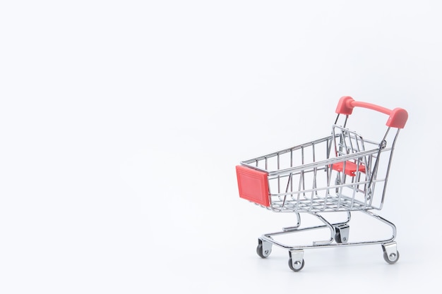 Shopping concept - Red shopping cart on white background with copy space