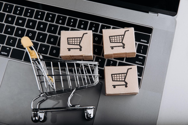 Shopping online and delivery concept Cardboard boxes with a shopping cart on a keyboard