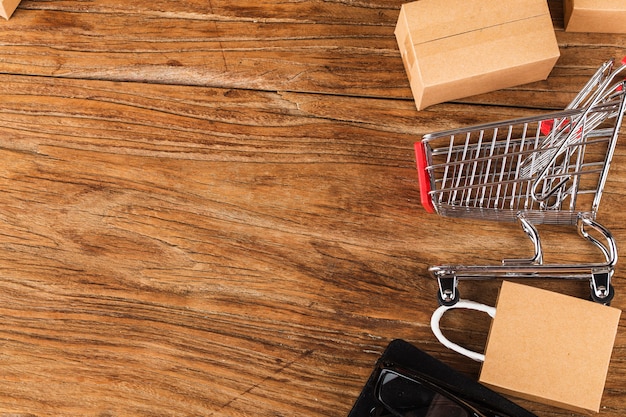 Shopping online at home concept. Cartons in a shopping cart on a laptop keyboard. 