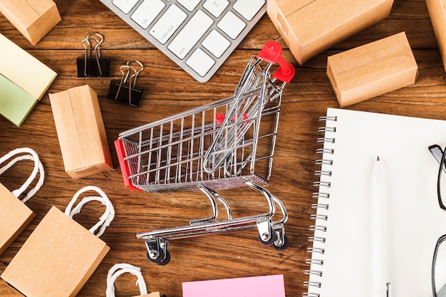 Shopping online at home concept. Cartons in a shopping cart on a laptop keyboard. 