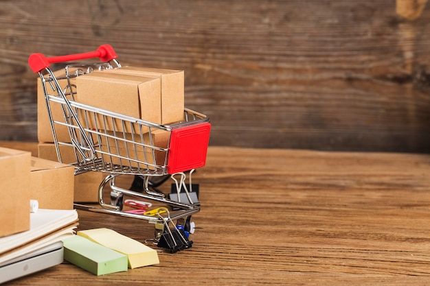 Shopping online at home concept.Cartons in a shopping cart on a laptop keyboard