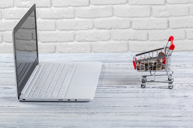 Shopping Online   Mini Shopping Cart and Laptop