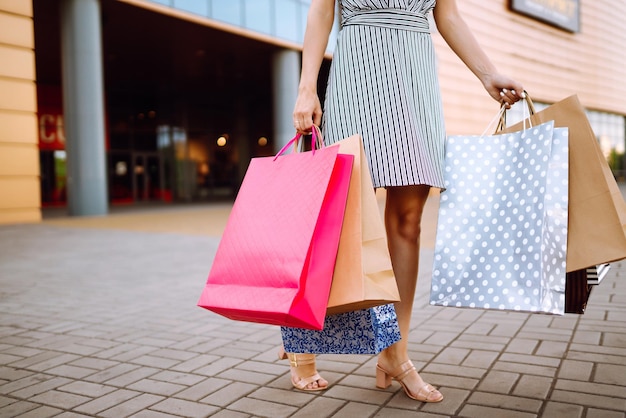 買い物の時間 モールの近くに買い物袋を持つ若い女性 消費者販売の購入