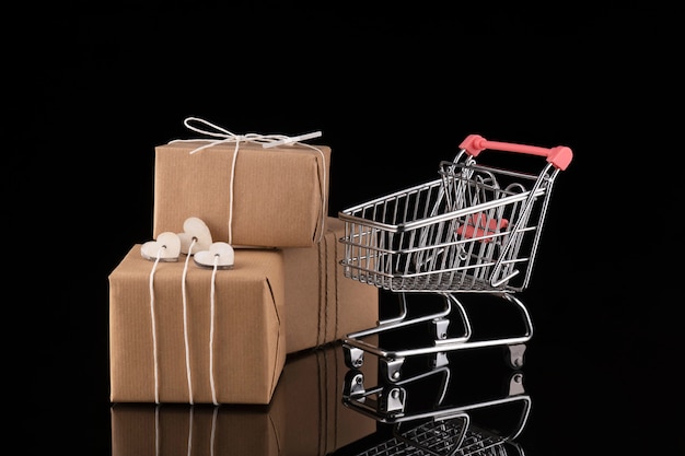 Shopping trolley cart and gift boxes. Buying presents concept, online shopping. Isolated