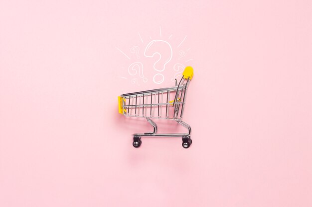 Shopping trolley from the supermarket on an isolated pink background.